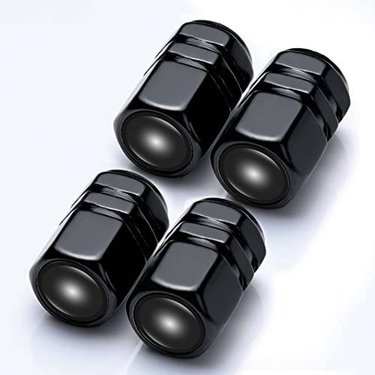 Four black tire valve caps with Mercedes logo, angled view