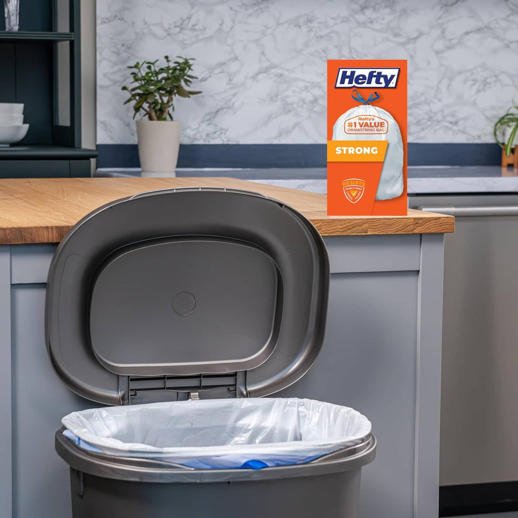 Hefty Strong tall kitchen drawstring trash bag liner in use inside a trash can