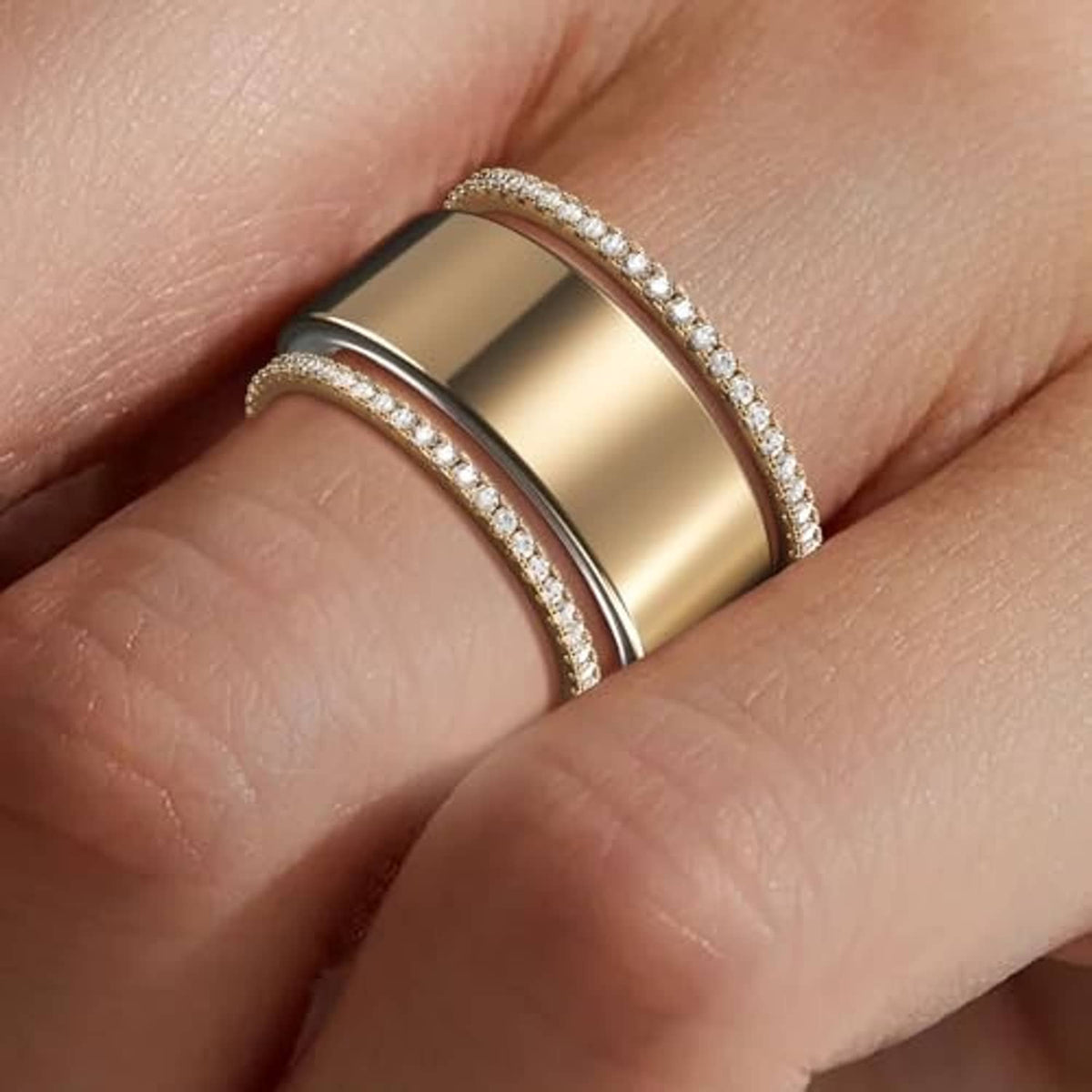 Gold stackable ring bands with pavé edges on a finger