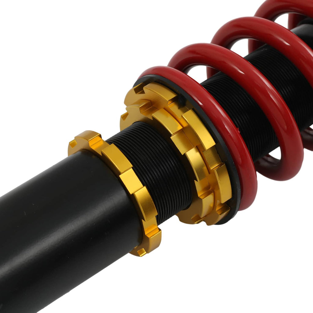 Coilover suspension shock with red spring, black body, gold threaded adjuster collar