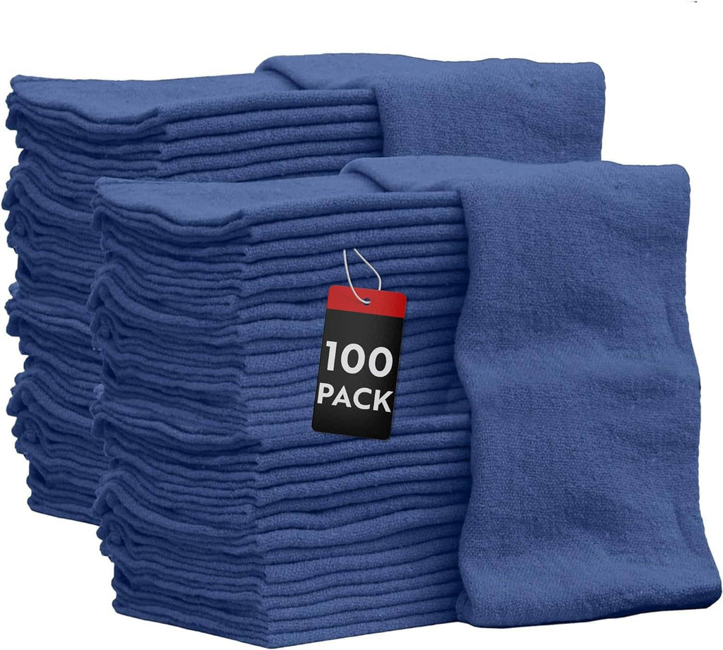 Blue shop towels in a folded stack with a hanging “100 pack” label