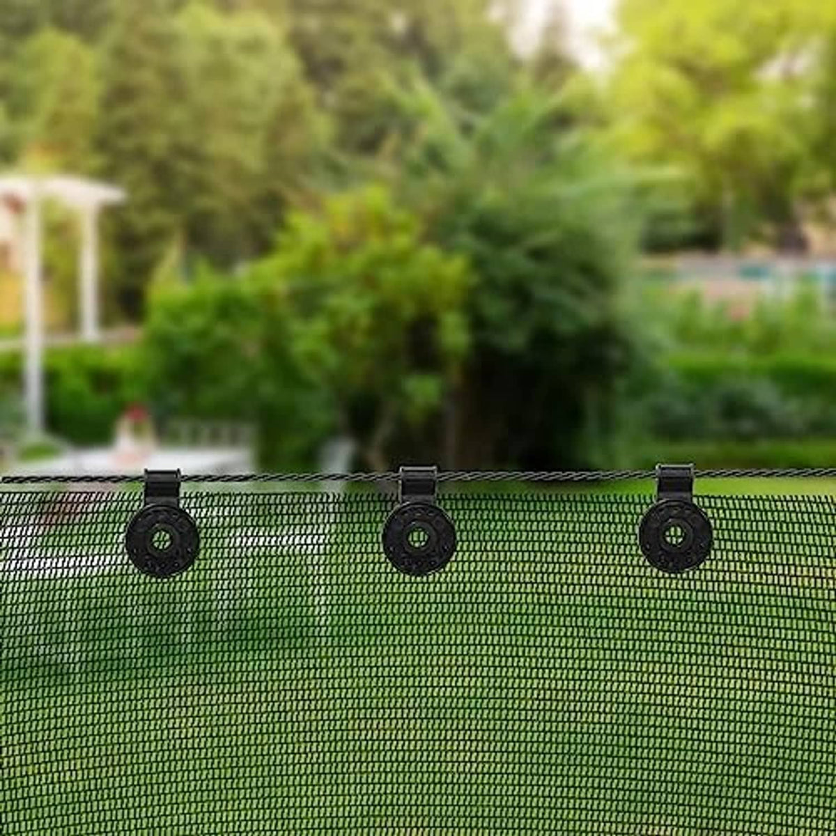 Three black round shade cloth clips attached along the top edge of mesh fabric