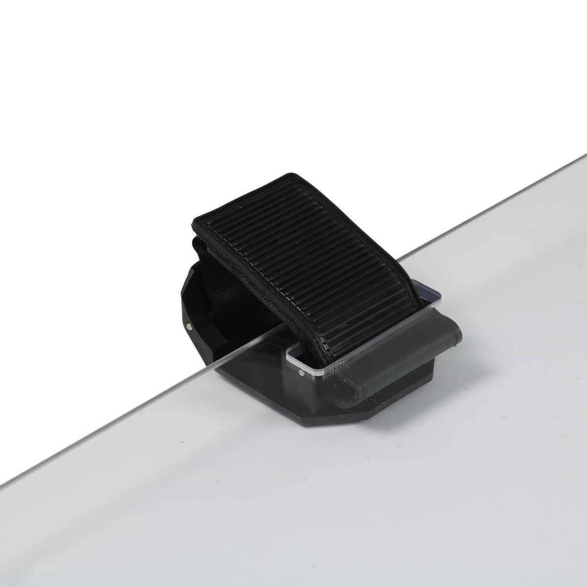 Front windshield hinge/lock bracket with ribbed black cover, on clear tinted panel.