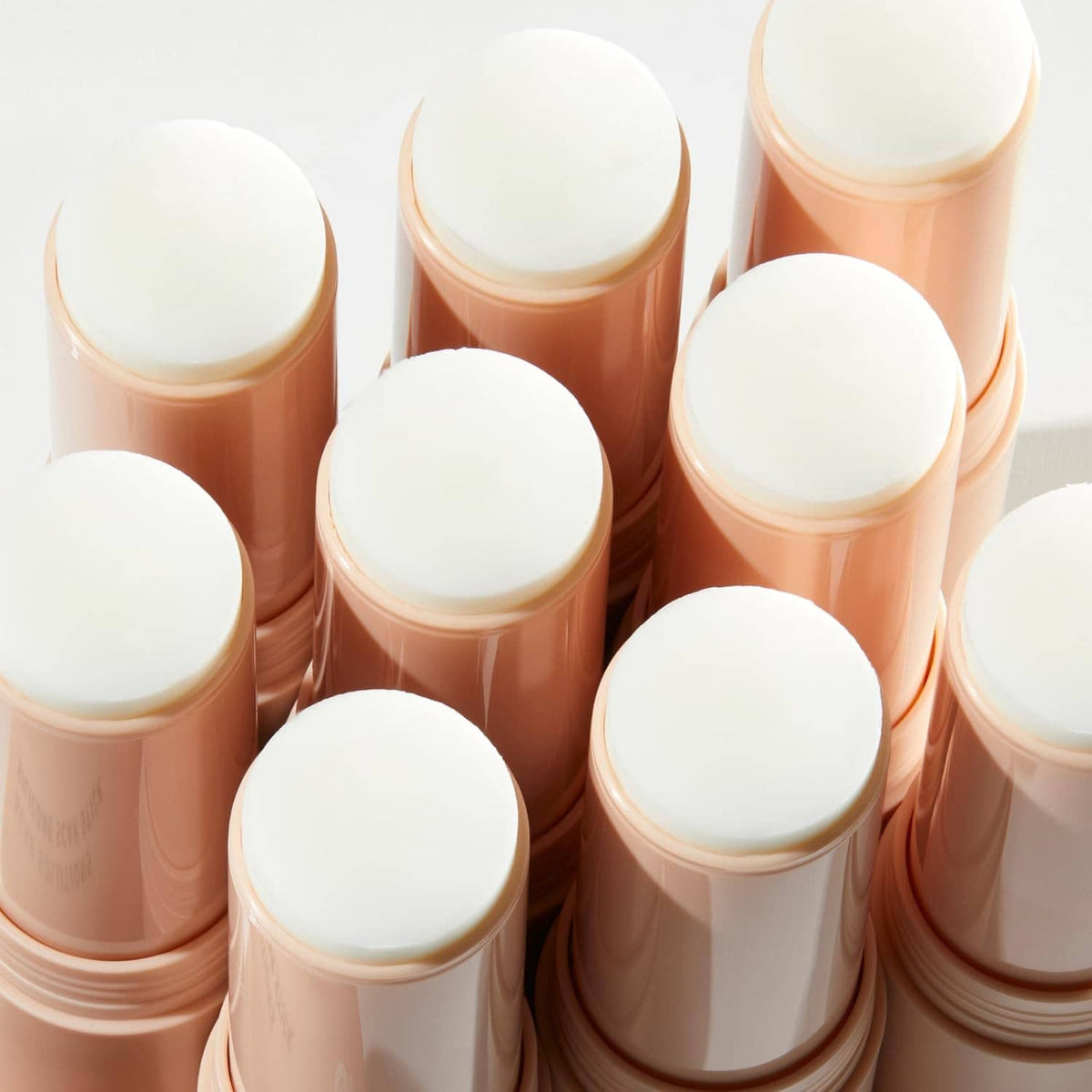 Multiple Prequel silicone scar sticks with white caps and beige balm cylinders