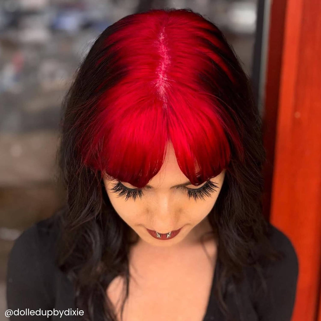 Dyed hair with vivid red bangs and dark waves, semi-permanent hair dye result