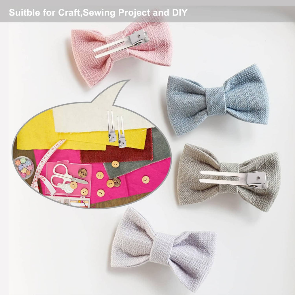 Silver double-prong metal hair clip attached to craft fabric, sectioning clip