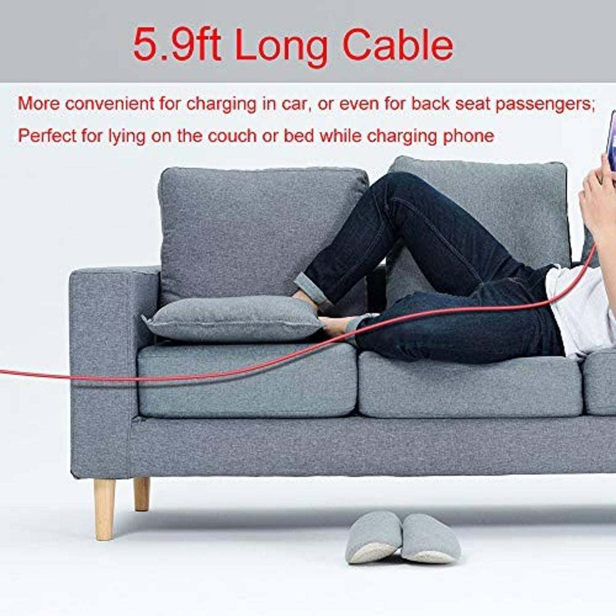 Red USB-A to Type-C cable stretched across a couch for charging