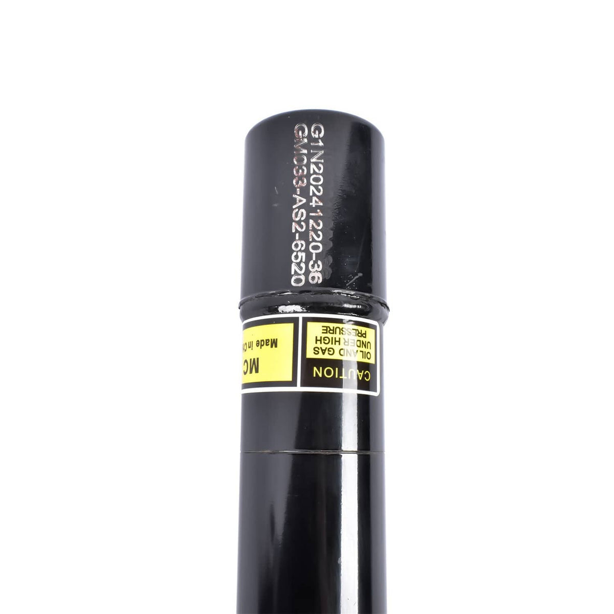 Black shock absorber body with printed serial label and yellow production sticker