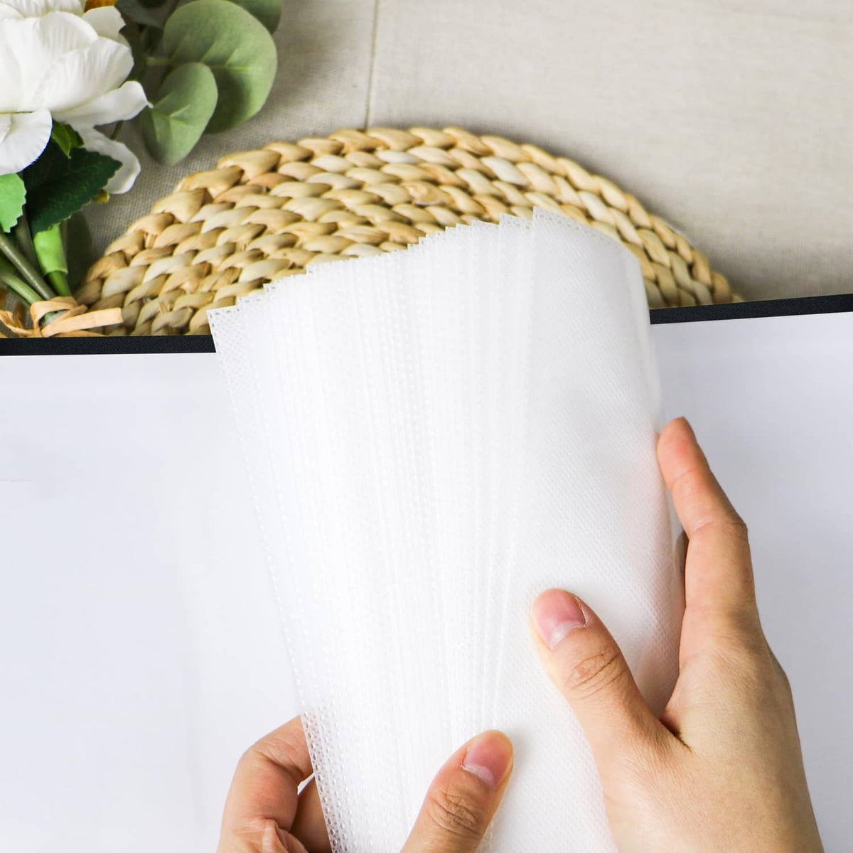 Inside page of a black photo album with white pocket sleeves