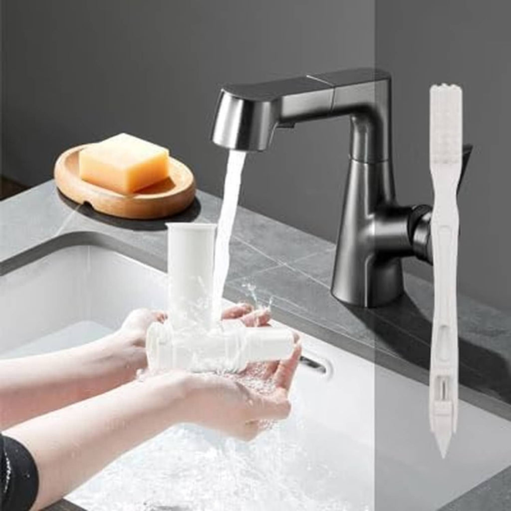 Pasta maker attachment with cleaning brush being rinsed under a kitchen sink faucet