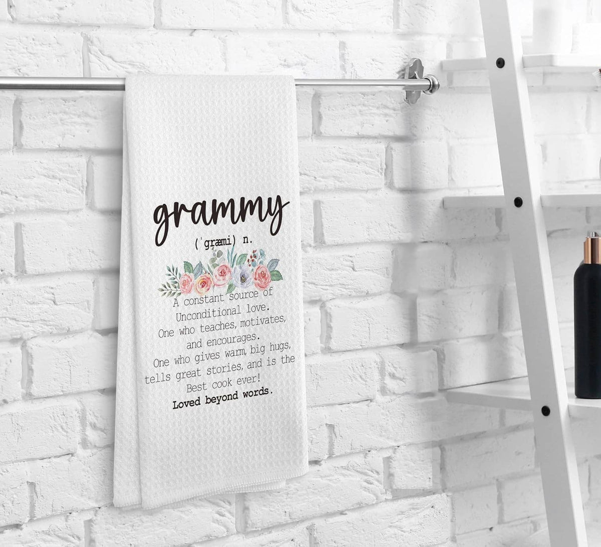 White kitchen towel hanging on rack with 'grammy' quote and floral roses