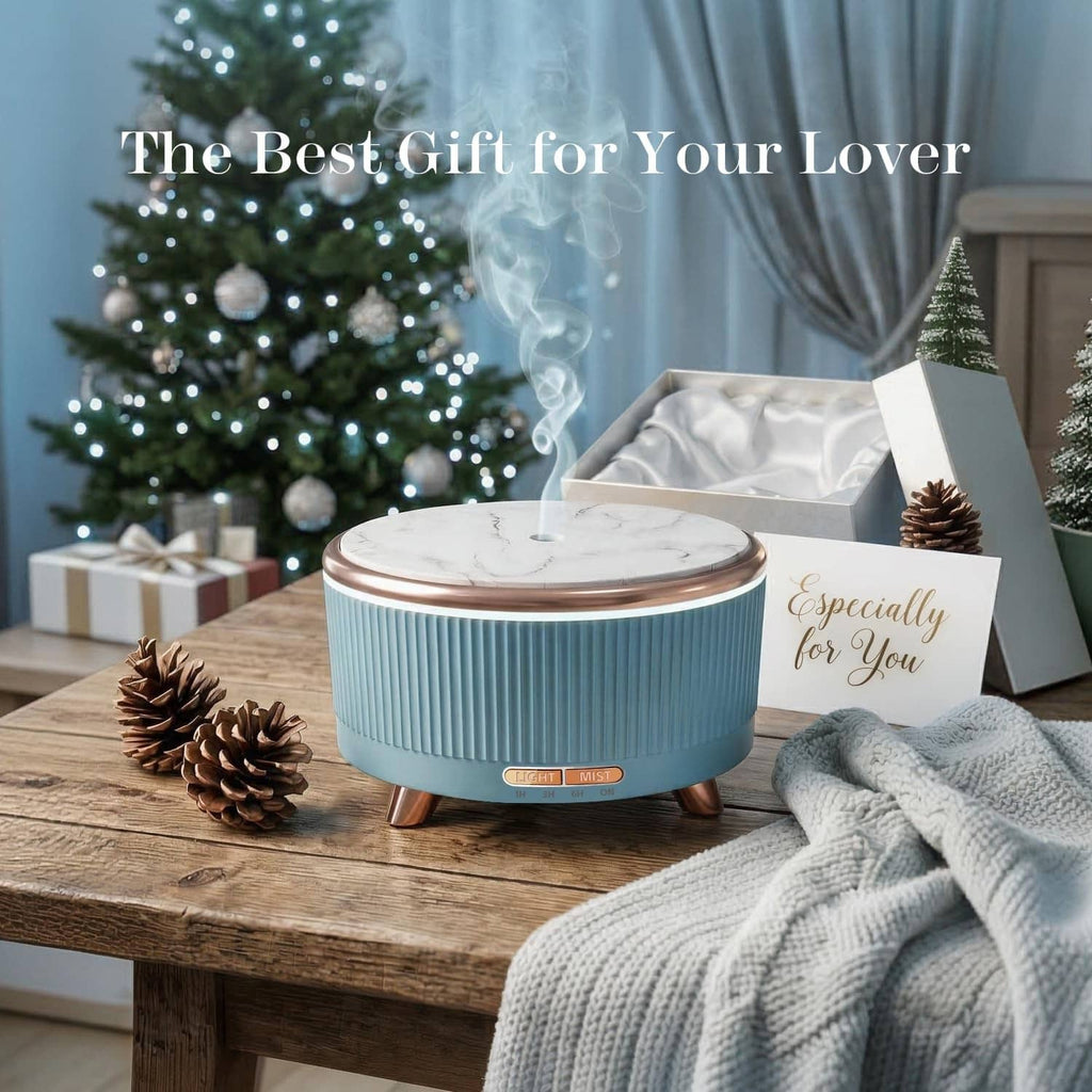 Blue ultrasonic essential oil diffuser with marble-style top and copper feet, releasing mist.