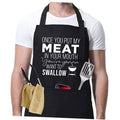 Black cooking apron with funny "MEAT...SWALLOW" grill slogan and fork/utensil graphic.
