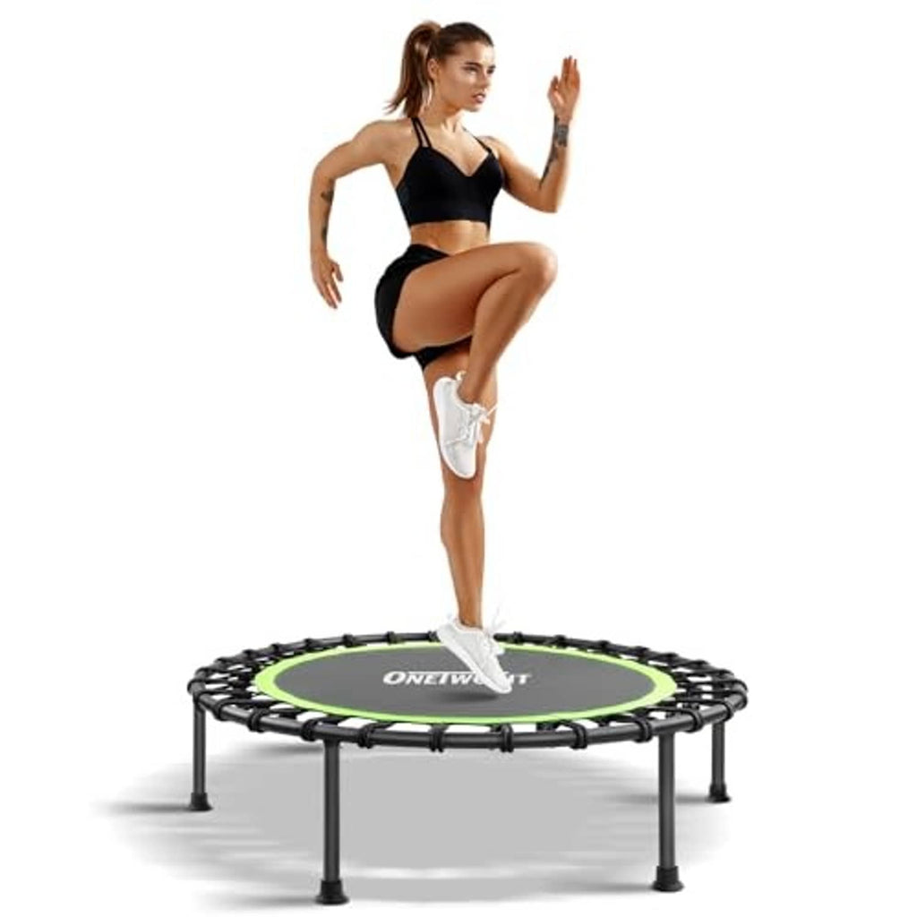Mini trampoline with round green deck, black springs and four short legs; woman standing