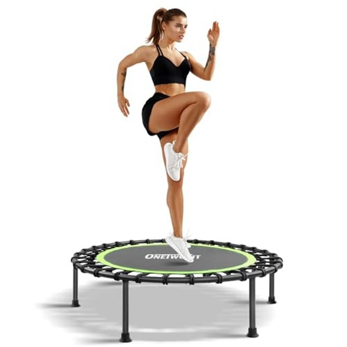 Mini trampoline with round green deck, black springs and four short legs; woman standing