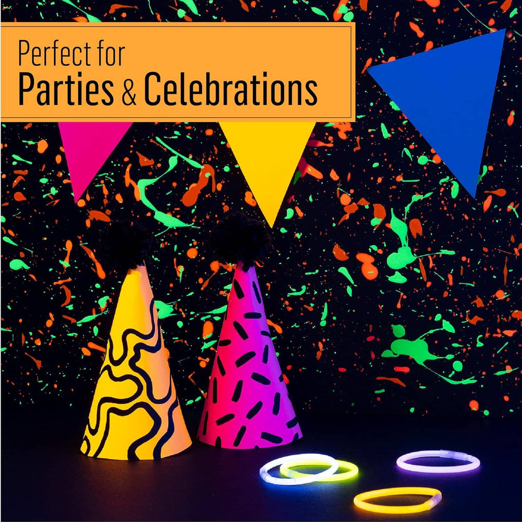 Glow-in-the-dark paint applied to party cones and glowing bracelets on tabletop.