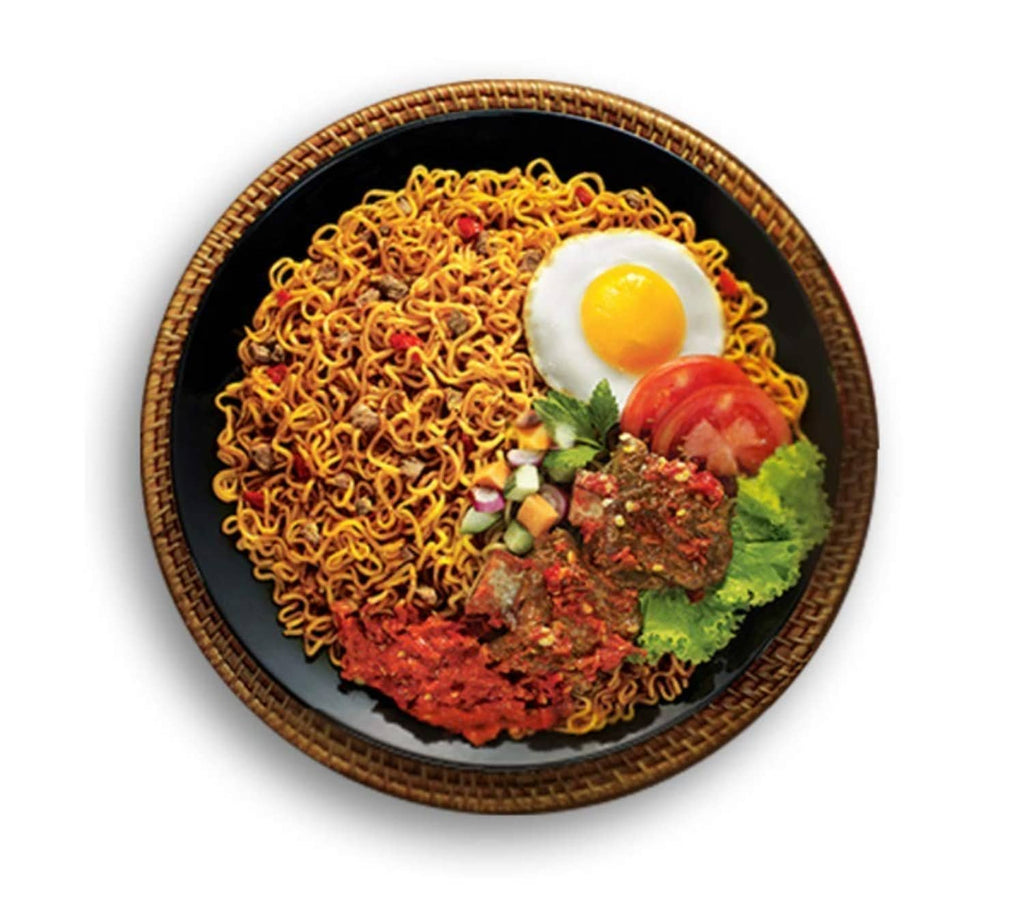 Plate of fried noodles with a sunny-side-up egg and vegetable toppings