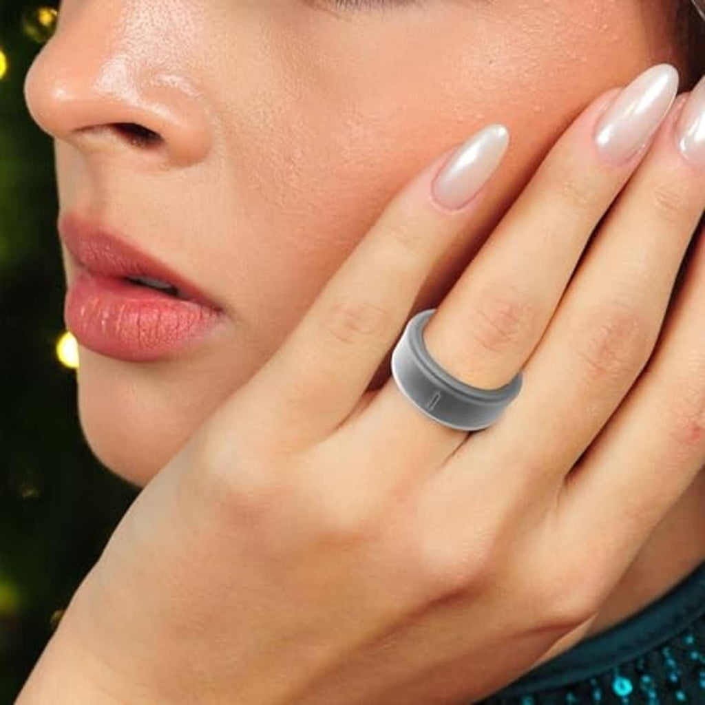 Gray silicone ring cover worn on a finger with short, glossy nails
