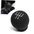 Round black manual gear shift knob cover with 5-speed shift pattern markings