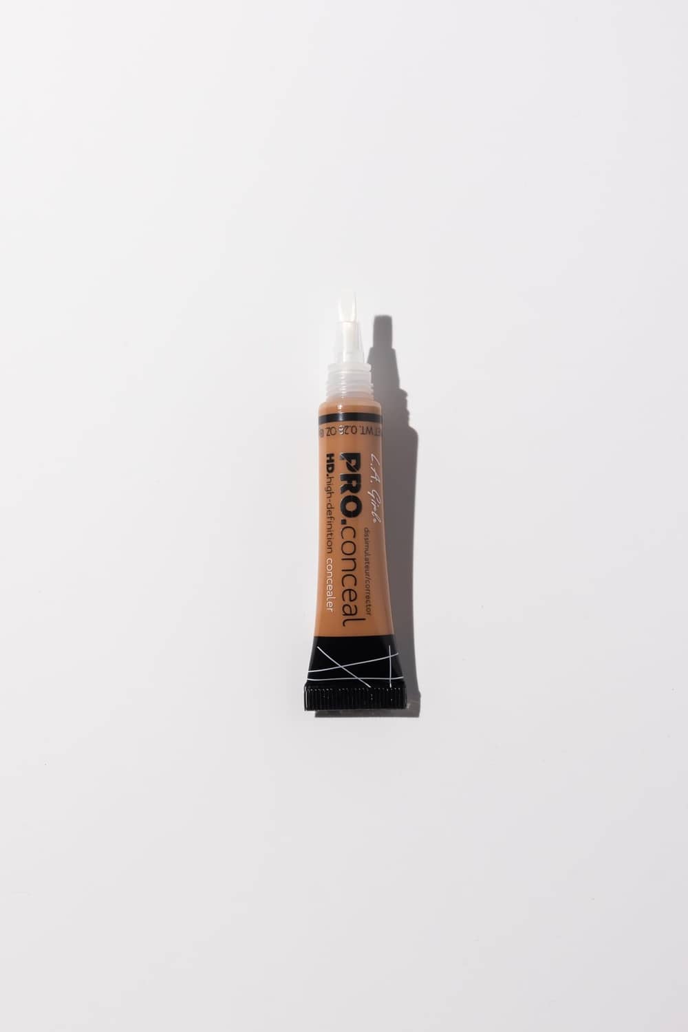 Cool tan concealer tube with open dropper tip applicator