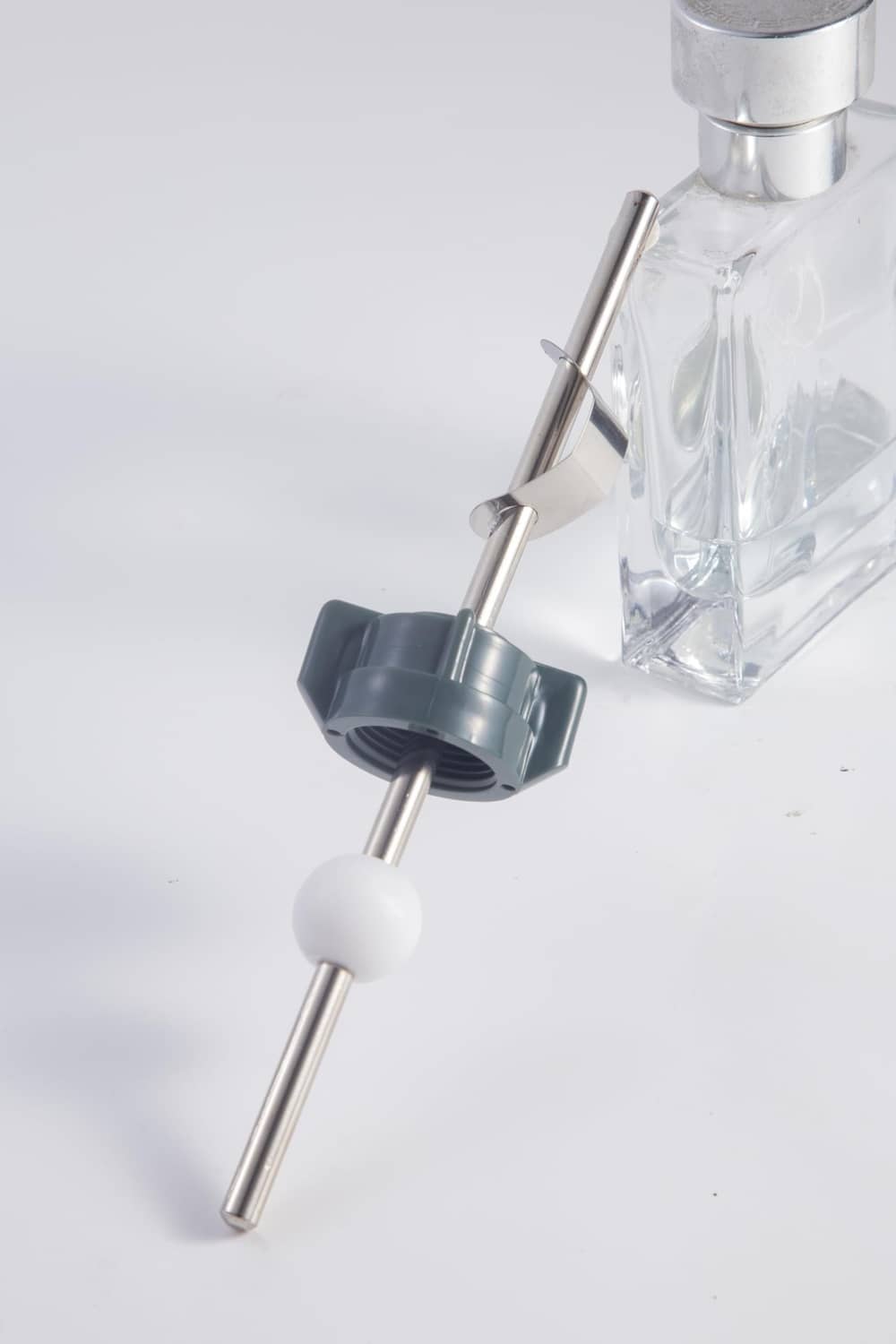 Pop-up drain linkage kit with metal rod, blue clip, and white ball stopper