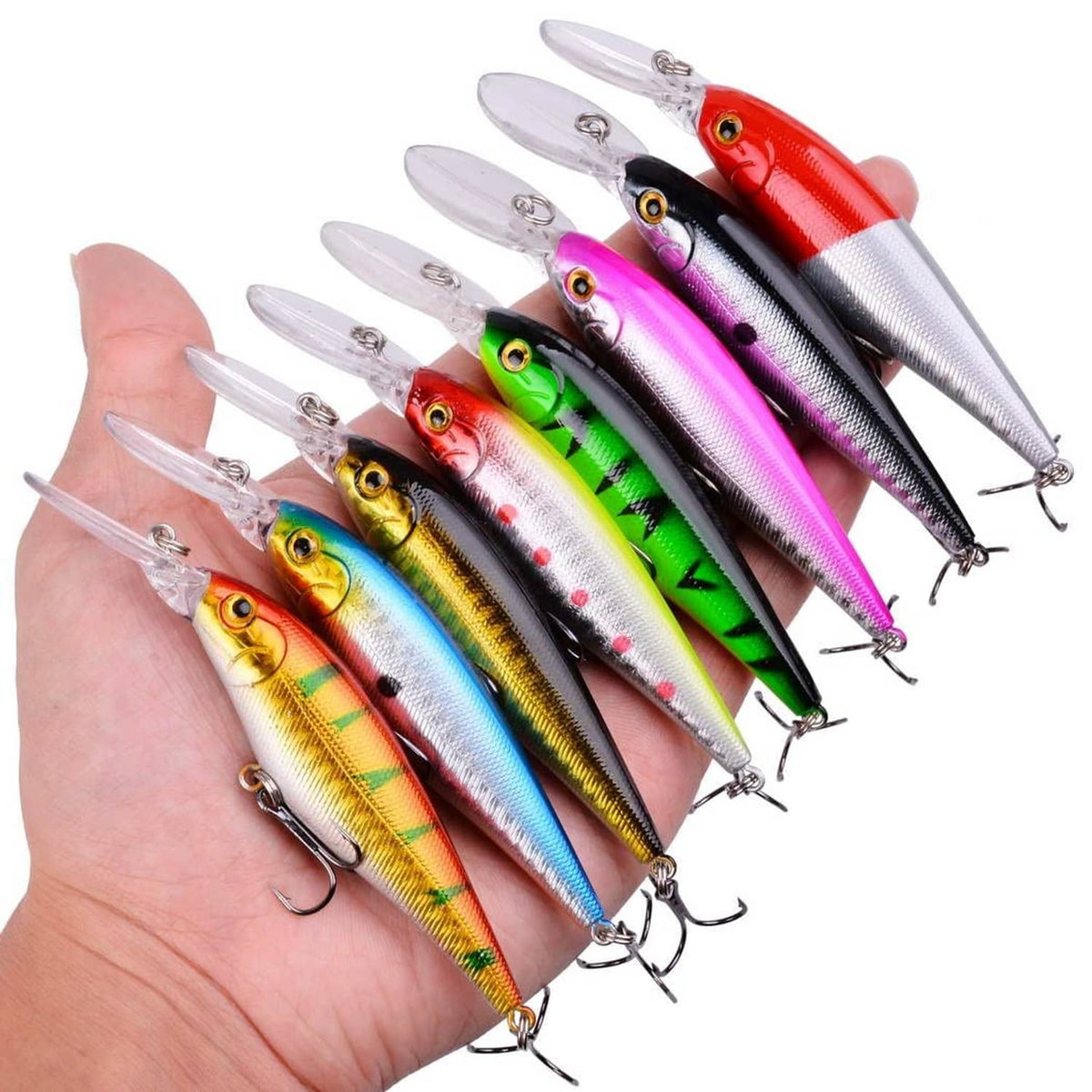 Assorted minnow lures, seven multicolor lures in hand with clear lips and treble hooks