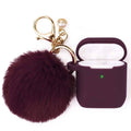 Silicone wireless earbud case cover with keychain and dark maroon fuzzy pom-pom