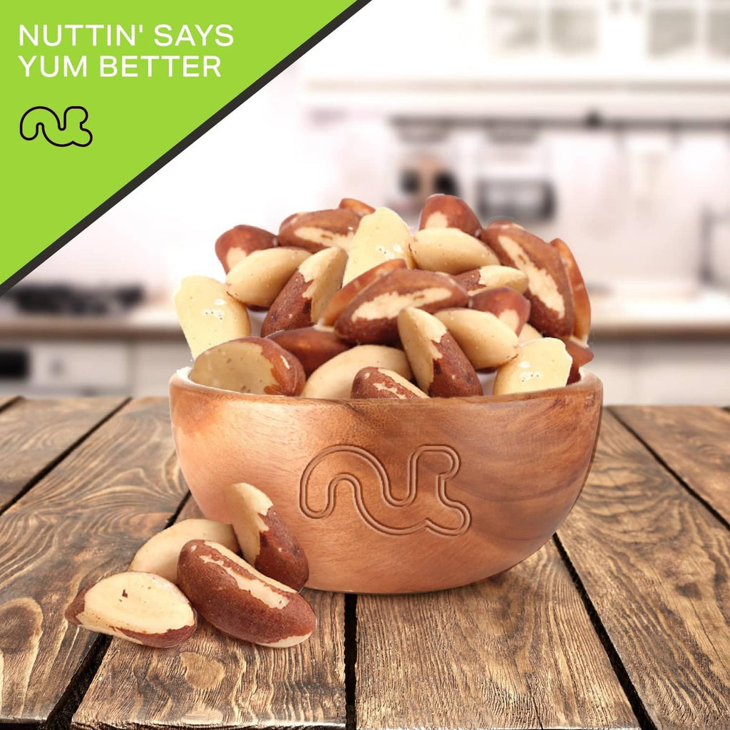 Roasted salted Brazil nuts in a carved wooden serving bowl