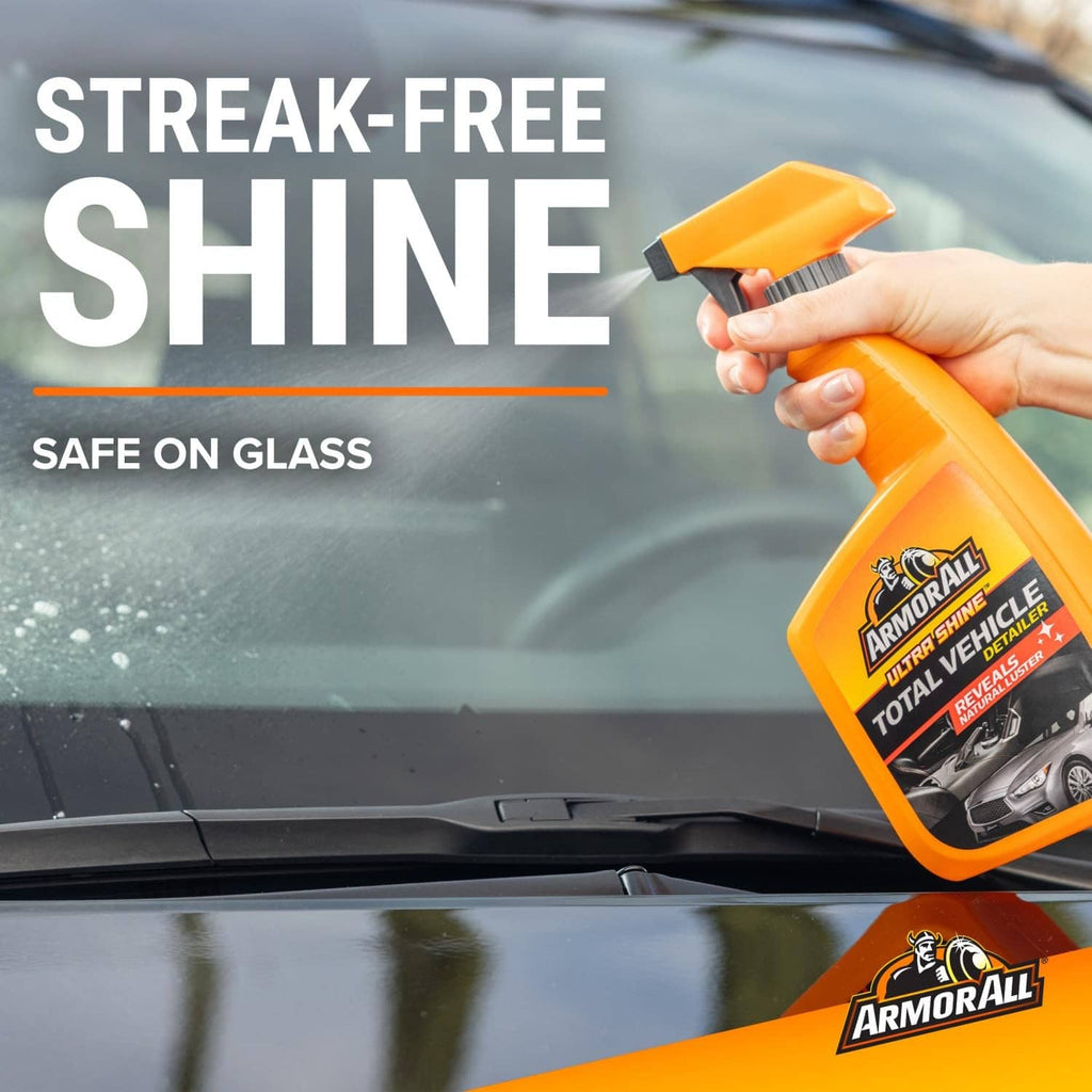 Windshield detailing: orange spray bottle applying streak-free shine on glass