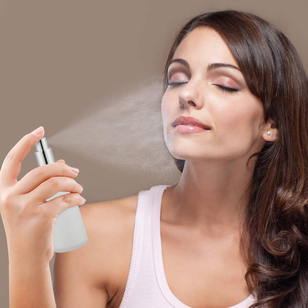 Frosted glass spray bottle with silver pump top, handheld mist sprayer