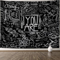 Black and white inspirational wall tapestry with doodles and “YOU ARE” lettering