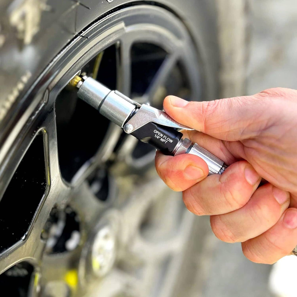 Tire inflator connector pressed onto a Schrader valve by hand