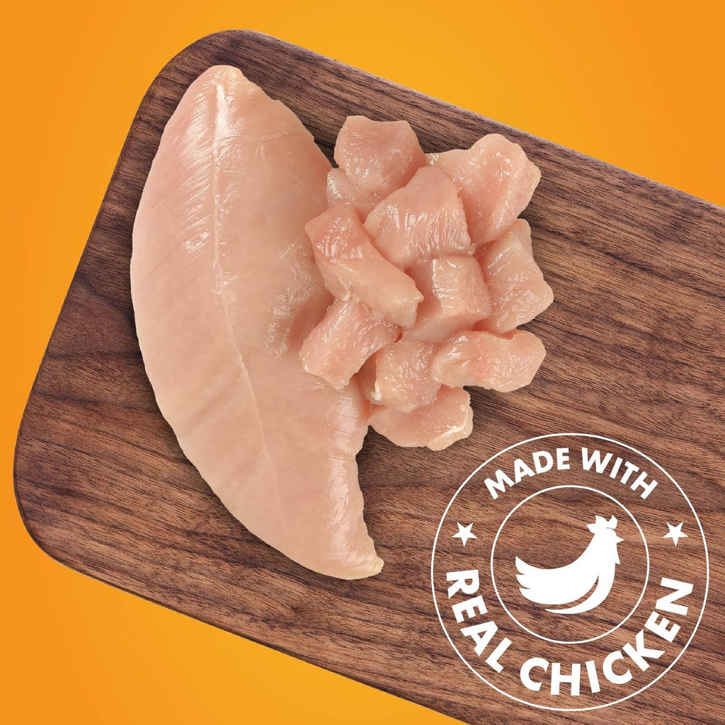 Pur Luv real chicken wrapped sweet potato dog treat pieces on wooden board