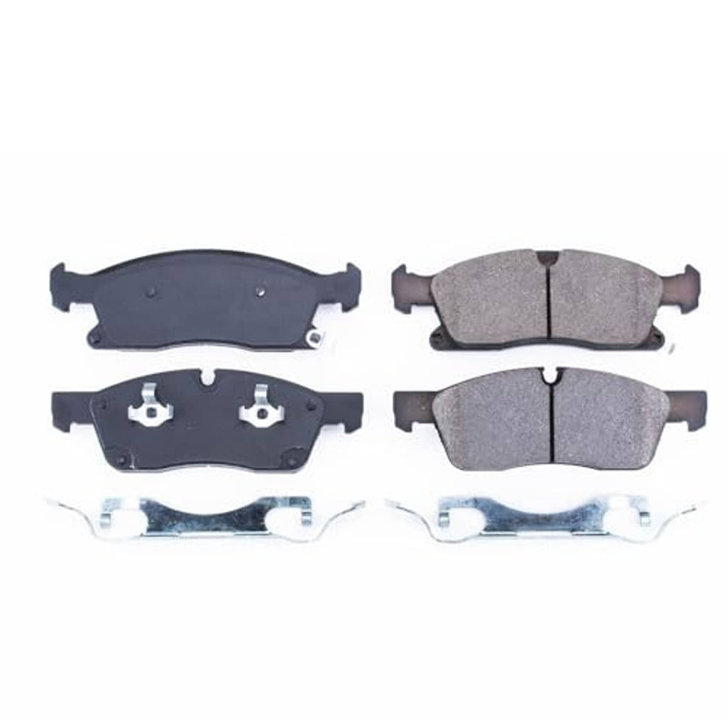 Set of front brake pads with backing plates and gray ceramic friction surfaces