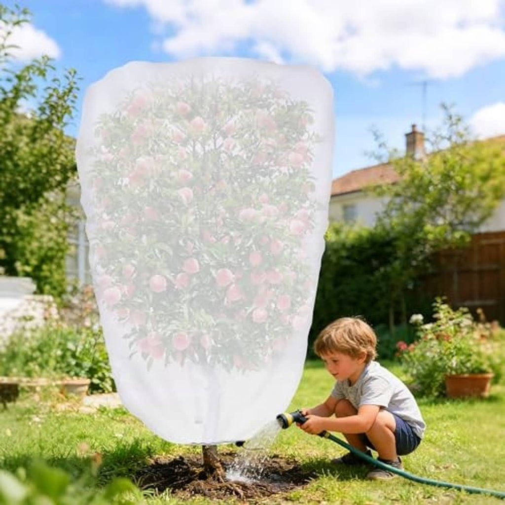 Garden plant shade cover with drawstring, white mesh over fruit tree, outdoor garden