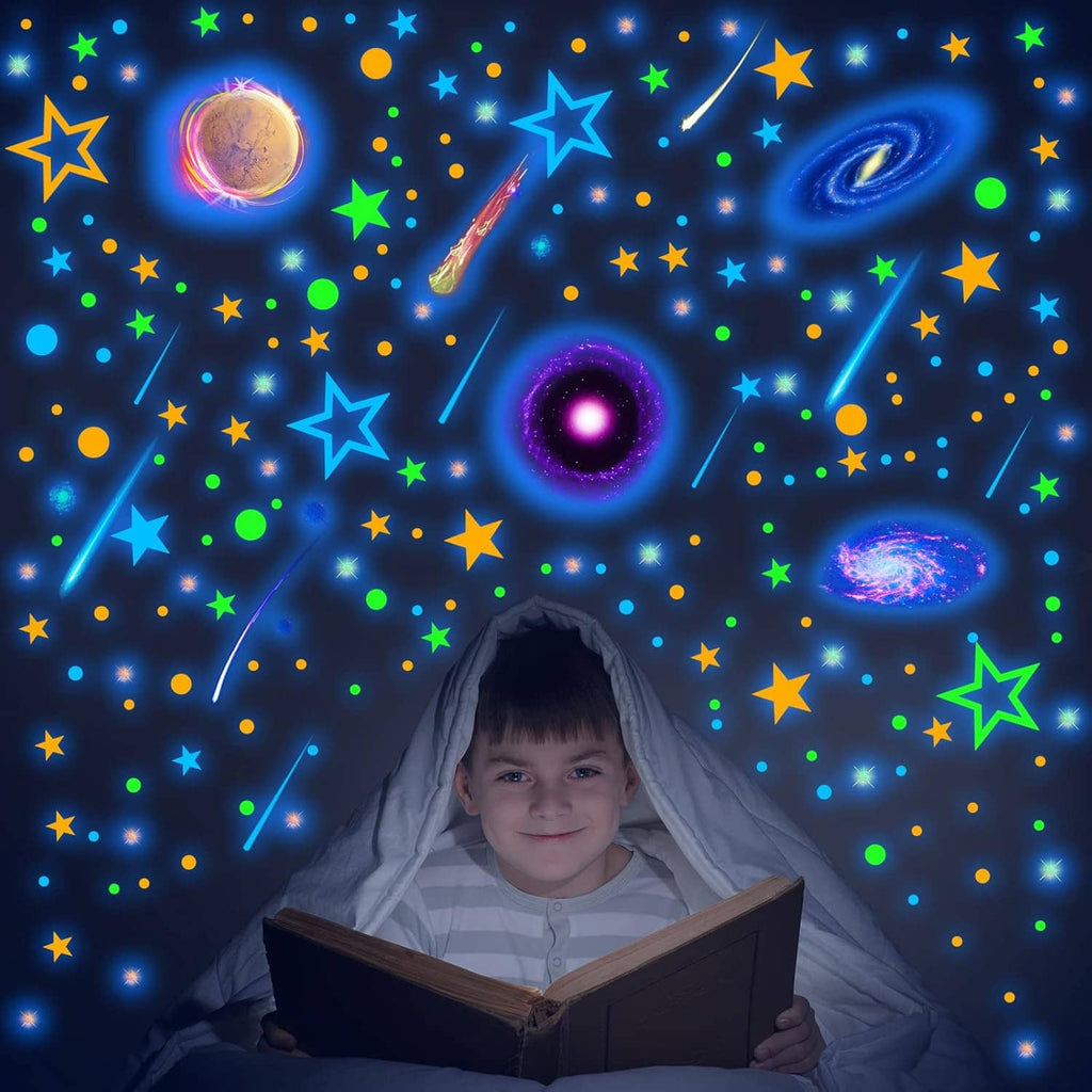 Glow-in-the-dark planet and star wall decals with a purple ringed planet centerpiece