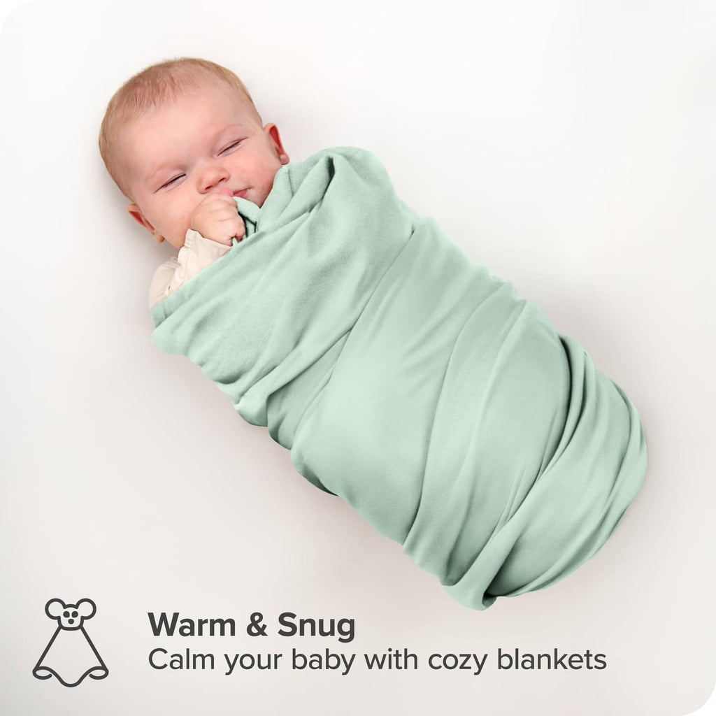 Mint green cotton flannel baby blanket swaddling a sleeping infant
