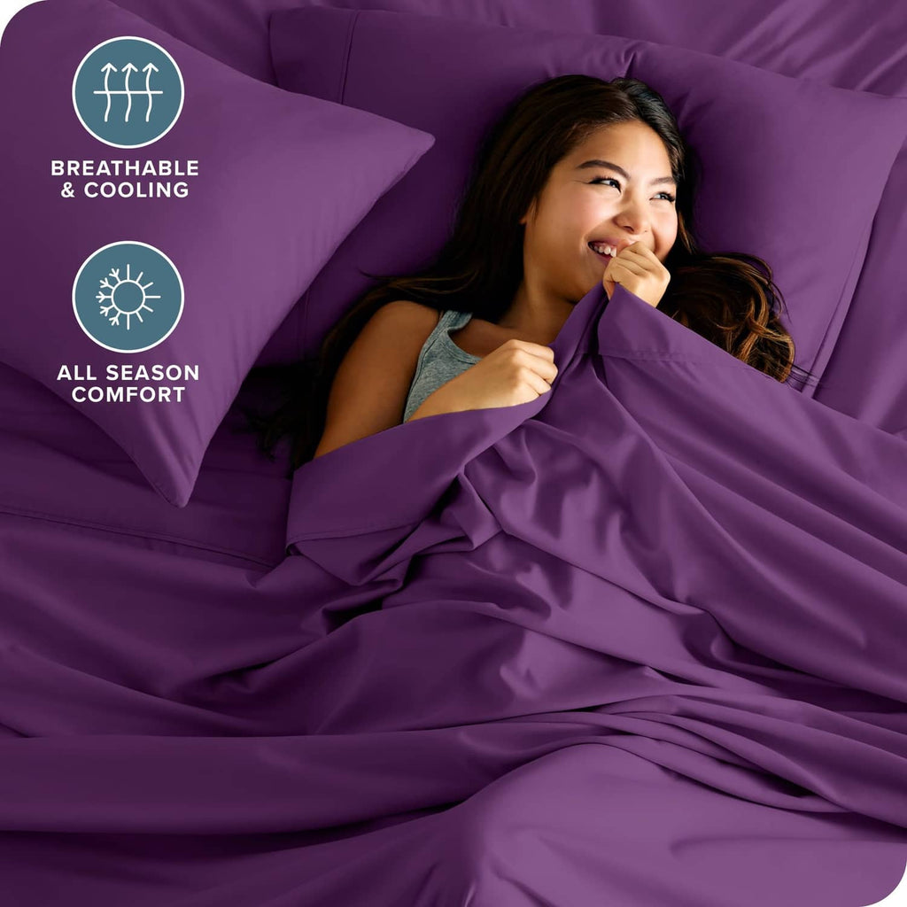 Plum twin bed sheet set with two pillowcases and neatly made flat sheet