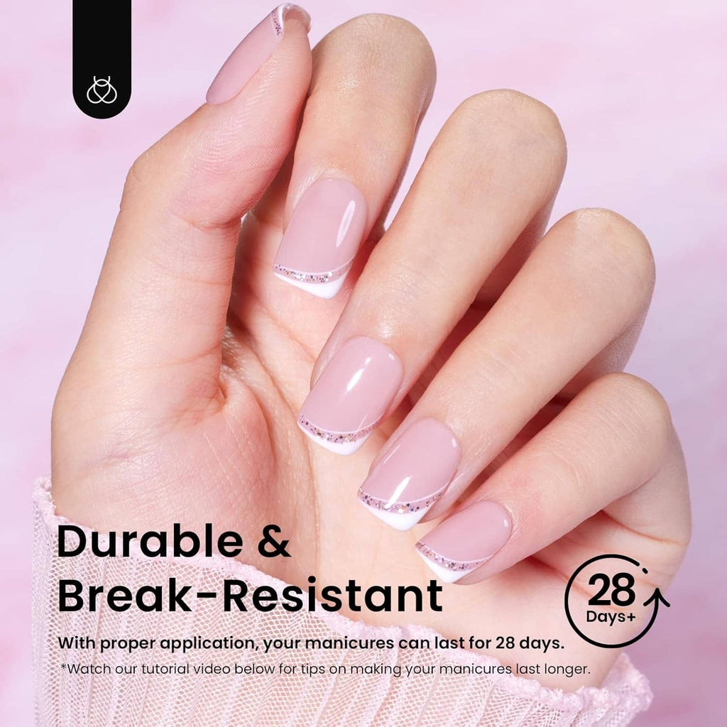 Hands with short square nail tips featuring sheer pink base and thin white French tips