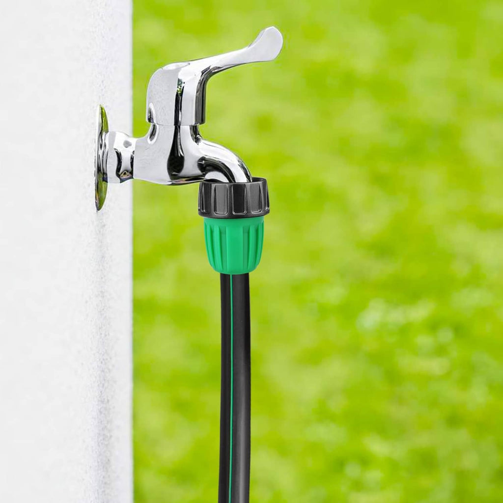 Green and black drip adapter connected to a garden faucet spout