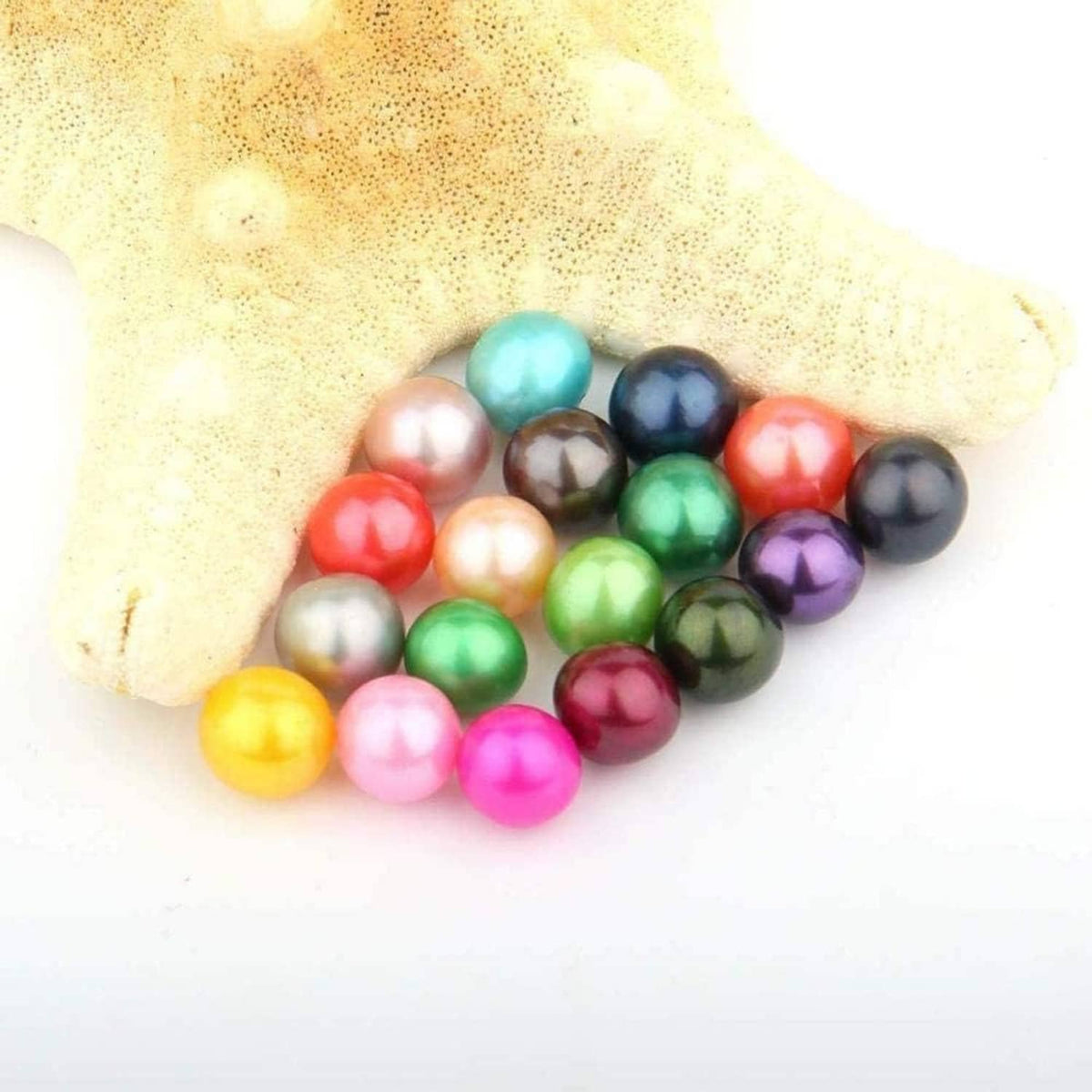 Assorted round pearl beads in green, pink, blue, gold, and black tones