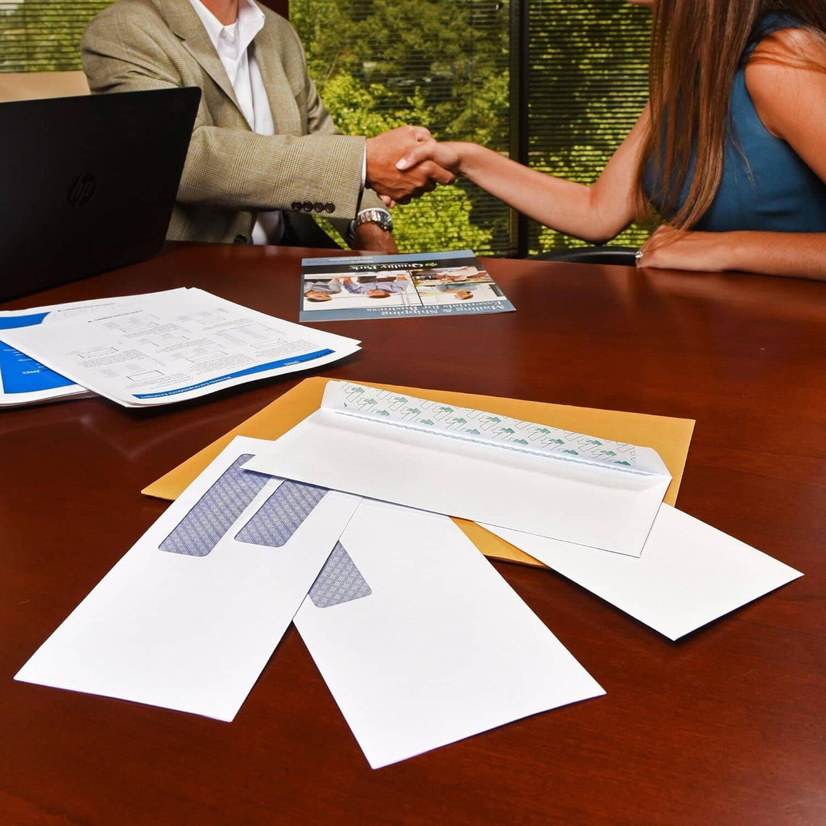 White security envelopes with blue double windows on a table