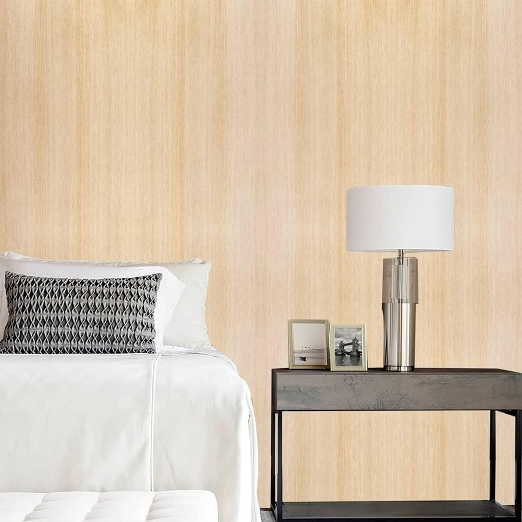Light oak woodgrain contact paper on a wall behind a bed and console table