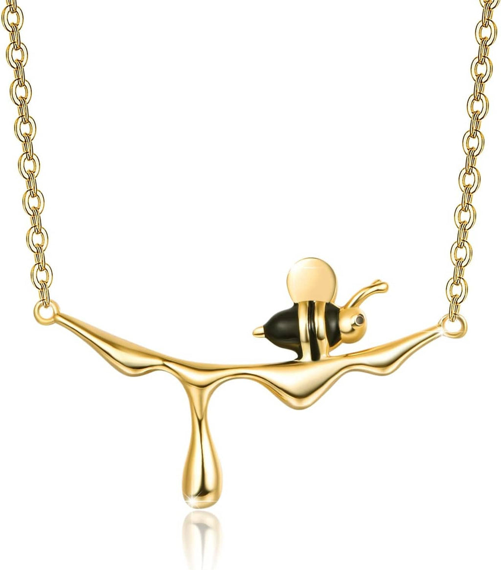 Gold-tone bee pendant necklace with black enamel accents and slim link chain