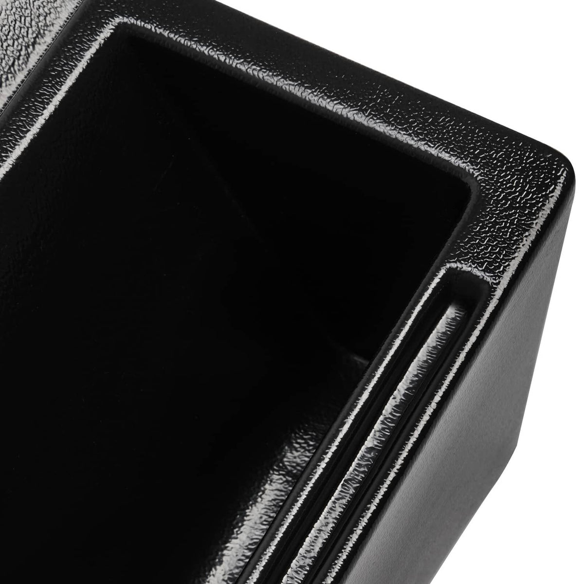 Close-up of black cab caddie corner with large empty tray and edge trim.