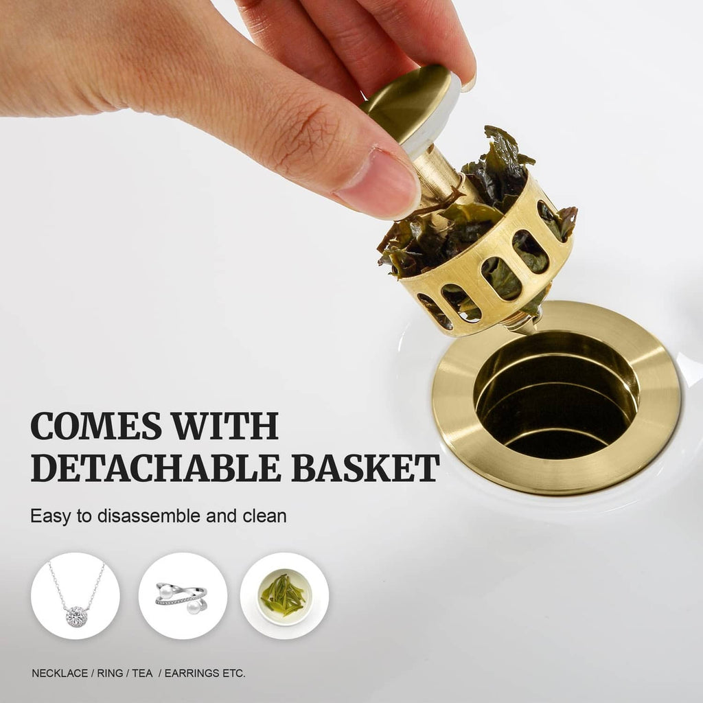 Brushed gold pop-up drain stopper with detachable basket, hand lifting the drain strainer