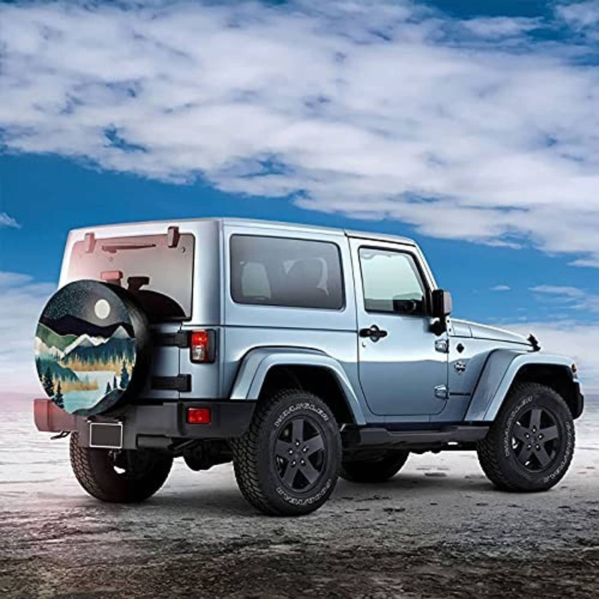 Spare tire cover on an off-road vehicle with starry night mountains and moon
