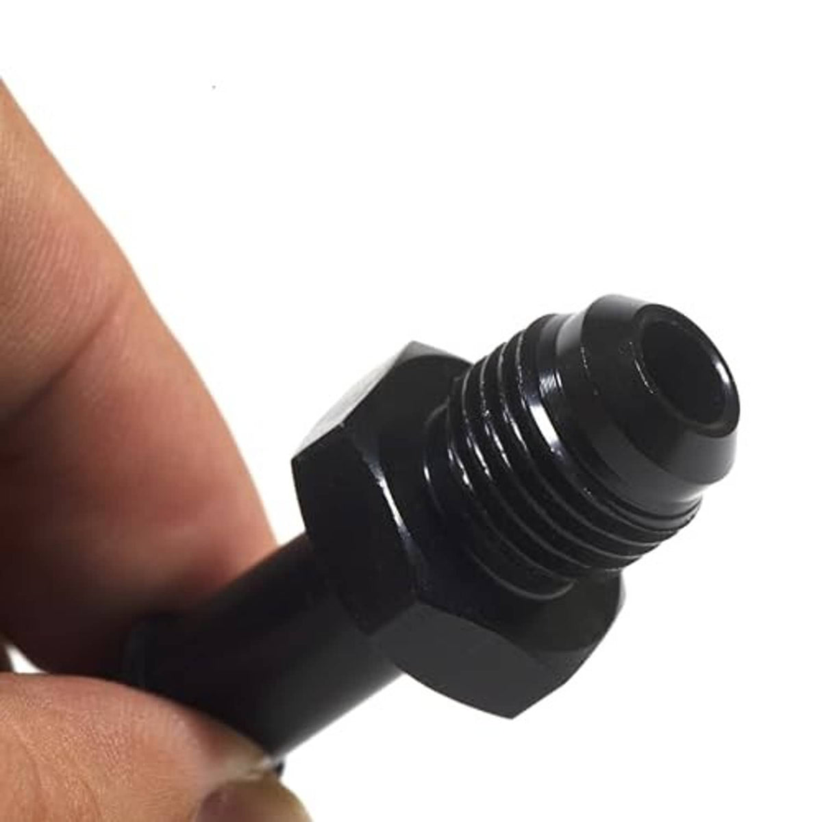 Black threaded adapter fitting in hand, showing hex section and hose barb