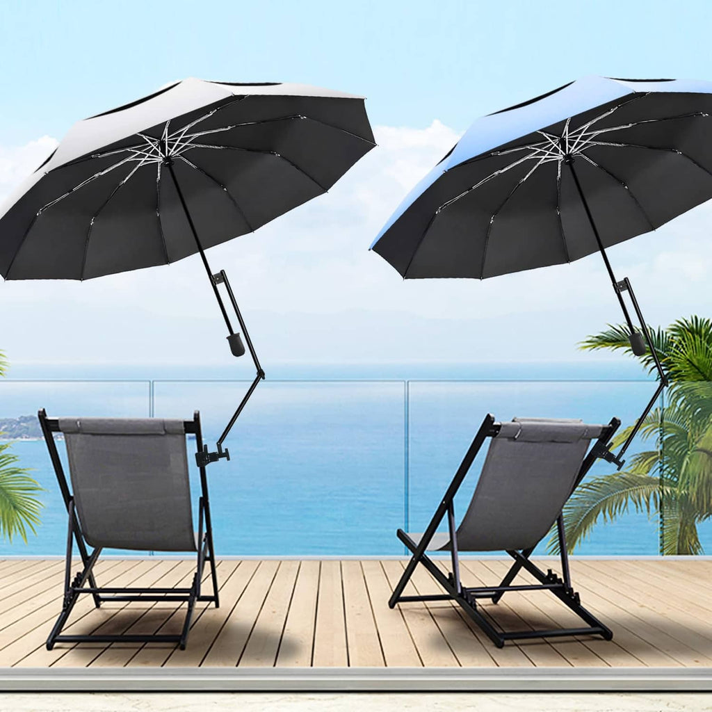 Pair of mounted golf umbrellas with dark canopies on a wooden deck by the sea.