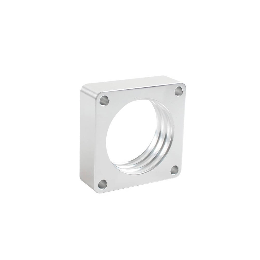 Silver throttle body spacer block with circular bore and four corner bolt holes